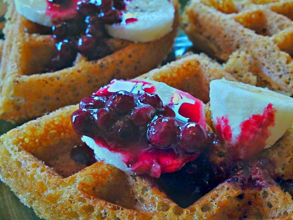 naked gluten-free vegan waffles with pomegranate blueberry syrup and banana