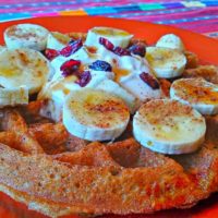 48-hour yeasted vegan waffle with coconut cream, bananas, dried cranberries